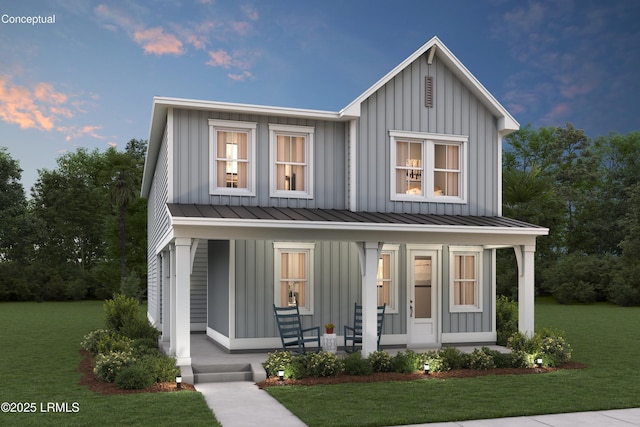 modern inspired farmhouse with board and batten siding, covered porch, metal roof, a yard, and a standing seam roof