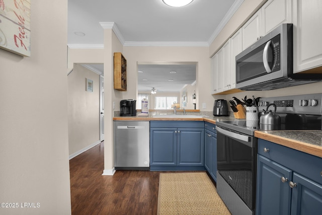 kitchen featuring blue cabinetry, stainless steel appliances, ornamental molding, white cabinets, and dark hardwood / wood-style flooring