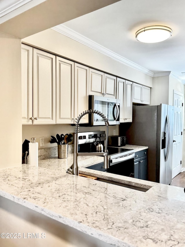 kitchen featuring appliances with stainless steel finishes, light stone counters, crown molding, sink, and white cabinetry