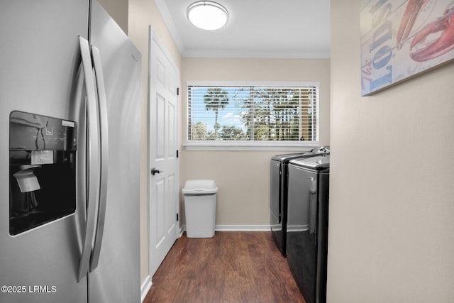 washroom with crown molding, washing machine and clothes dryer, and dark hardwood / wood-style floors