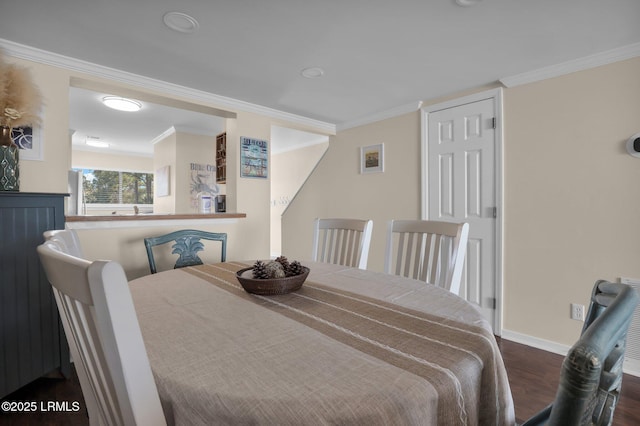 dining area with dark hardwood / wood-style flooring and ornamental molding