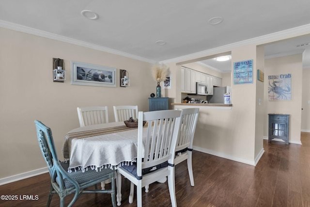 dining space with crown molding and dark hardwood / wood-style flooring