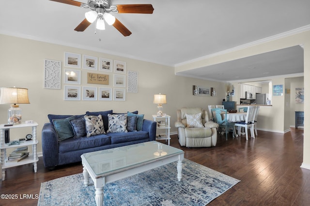 living room with dark wood-type flooring, ceiling fan, and ornamental molding