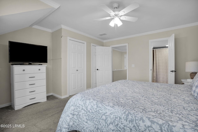 carpeted bedroom featuring ornamental molding, two closets, vaulted ceiling, and ceiling fan