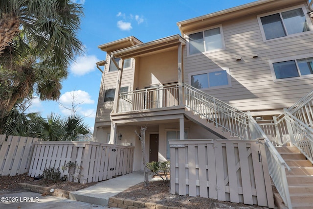 back of property with a balcony