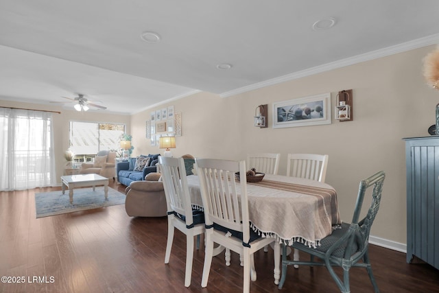 dining area featuring ornamental molding, dark wood-type flooring, and ceiling fan