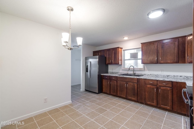 kitchen featuring decorative light fixtures, stainless steel fridge with ice dispenser, a sink, range with electric cooktop, and baseboards