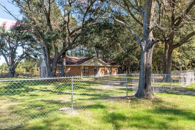 view of front of house with a front lawn, fence, and brick siding