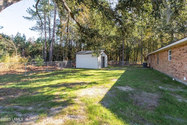 view of yard with a storage shed, central AC, an outdoor structure, and a fenced backyard