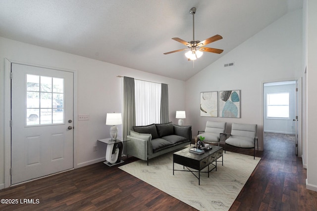 living area with baseboards, ceiling fan, visible vents, and wood finished floors