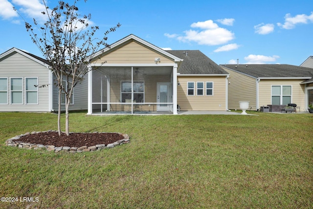 rear view of property with central AC, a patio area, a sunroom, and a lawn