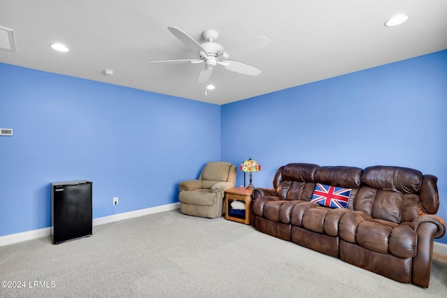 living room with ceiling fan and carpet