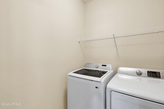 clothes washing area with washer and dryer