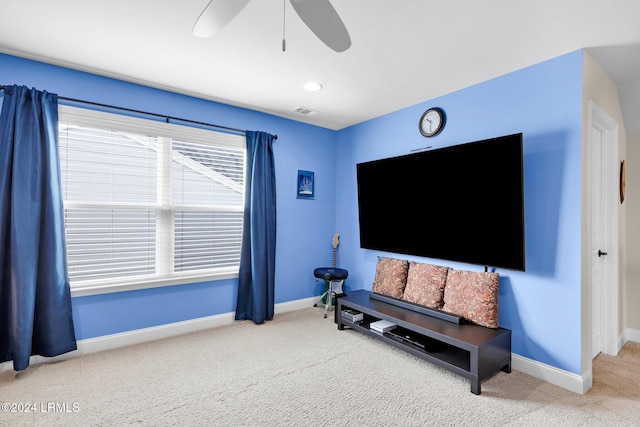 living area featuring ceiling fan and carpet