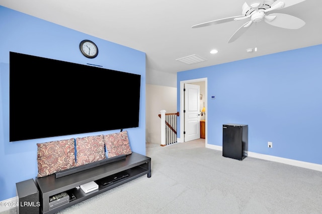 carpeted living room with ceiling fan