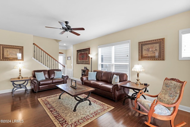 living room with dark wood-type flooring and ceiling fan