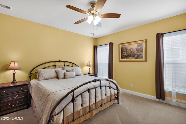 bedroom with ceiling fan and light colored carpet