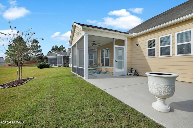 exterior space with a yard, a sunroom, a patio, and ceiling fan