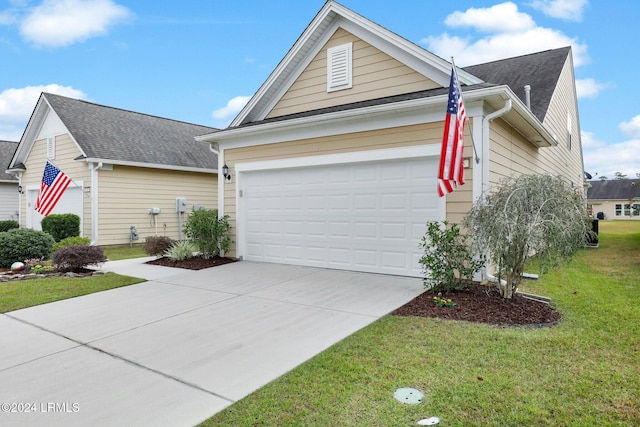 view of home's exterior with a garage and a lawn