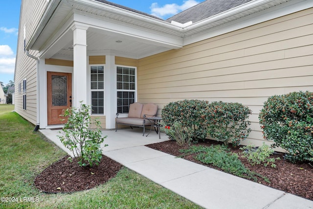 view of exterior entry with covered porch