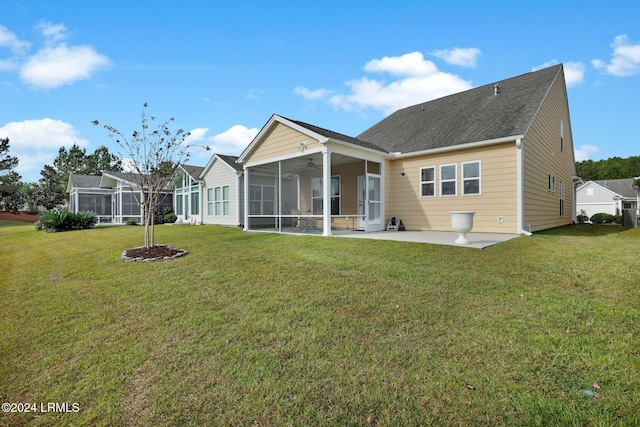 back of house with a yard, ceiling fan, and a patio area