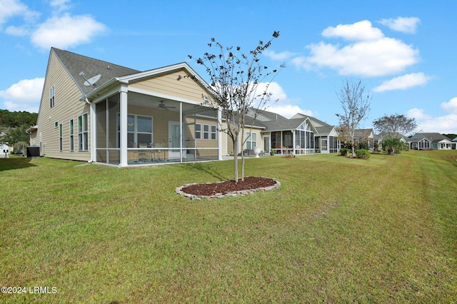 back of property featuring a sunroom, a yard, central AC, and ceiling fan