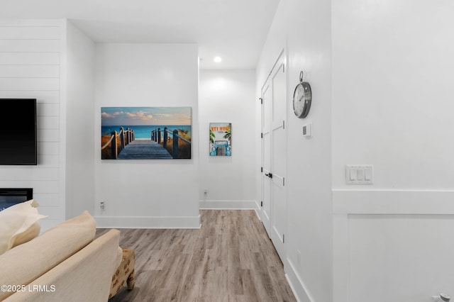 hallway with recessed lighting, wood finished floors, and baseboards