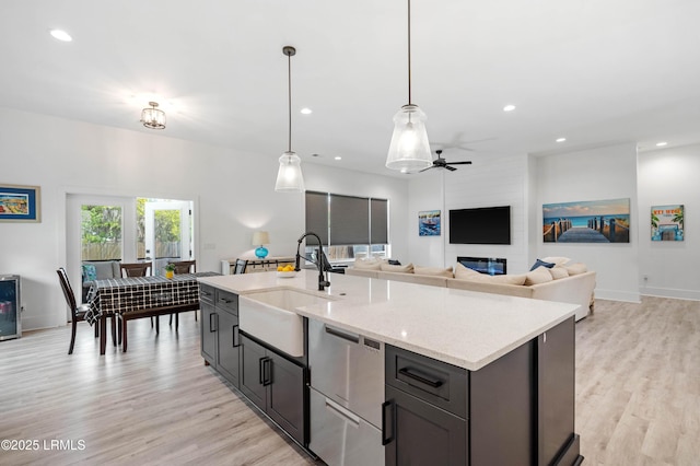 kitchen with recessed lighting, light wood finished floors, a sink, and ceiling fan