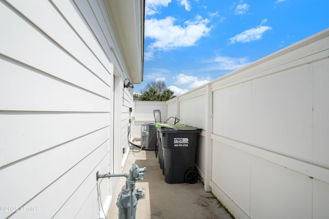 exterior details featuring fence, gas meter, and central AC unit