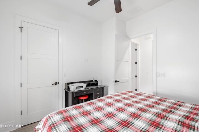 bedroom featuring visible vents, ceiling fan, and wood finished floors
