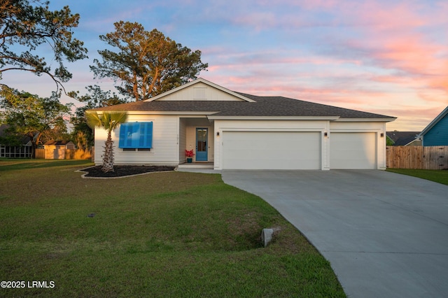 single story home featuring a lawn, driveway, roof with shingles, an attached garage, and fence