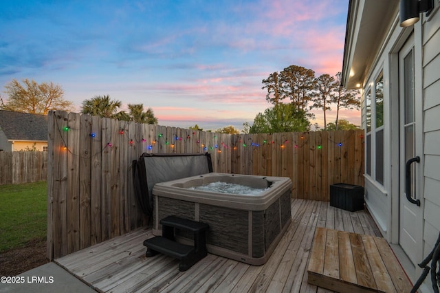 wooden deck featuring fence and a hot tub
