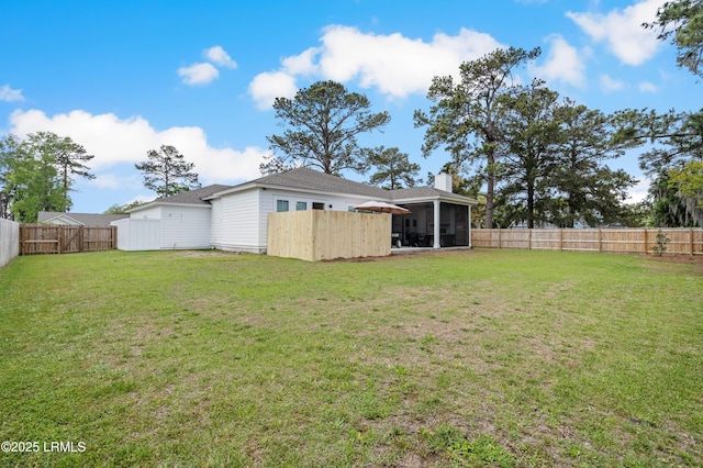 view of yard with a fenced backyard and a sunroom