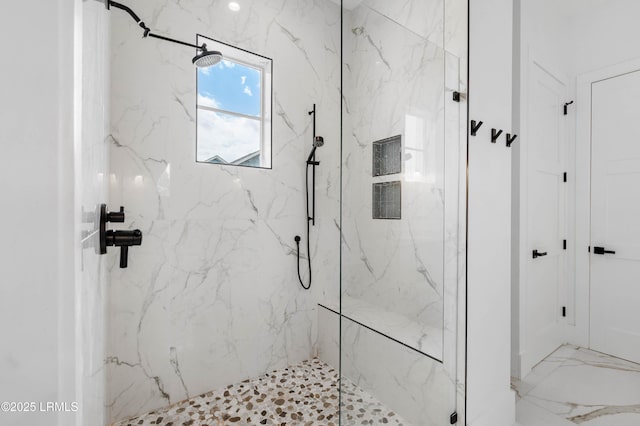 bathroom featuring a marble finish shower