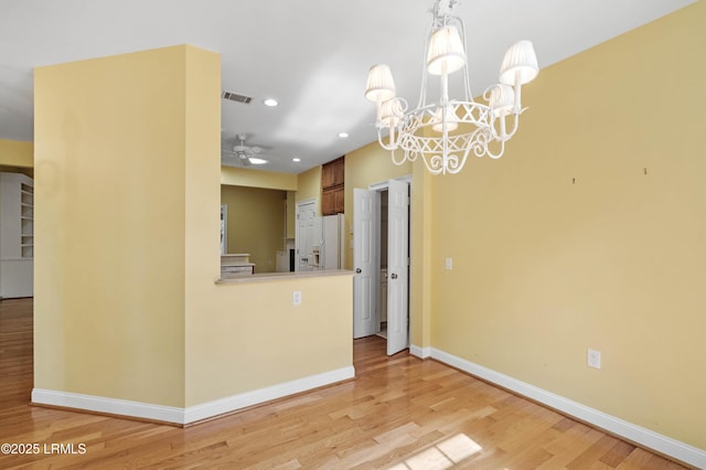 interior space with ceiling fan with notable chandelier, light wood-style flooring, baseboards, visible vents, and recessed lighting