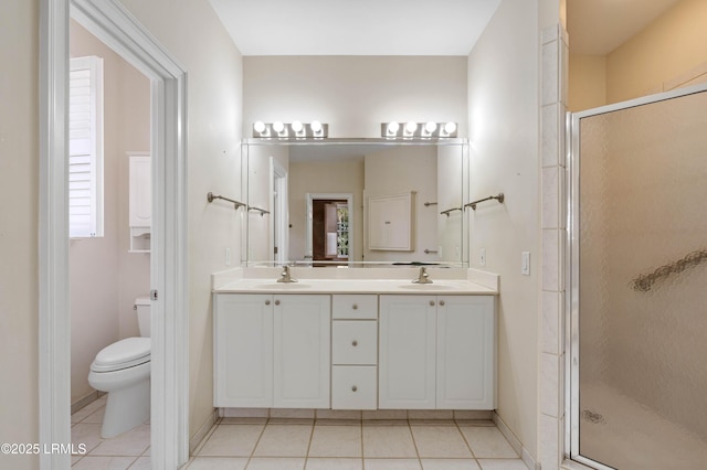 bathroom with tile patterned floors, a sink, and a shower stall