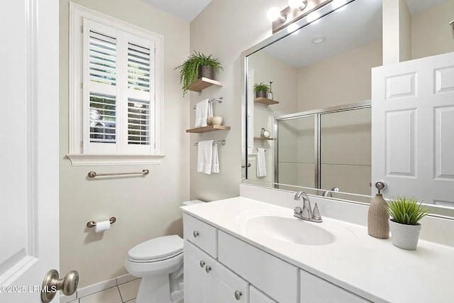 full bath with a shower stall, tile patterned flooring, vanity, and toilet
