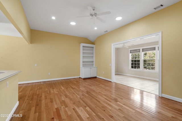 unfurnished living room featuring light wood-style floors, visible vents, baseboards, and ceiling fan