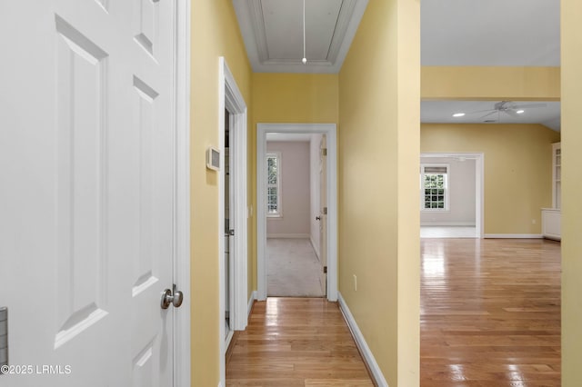 hall featuring attic access, baseboards, light wood finished floors, and recessed lighting