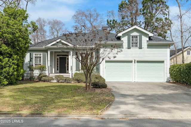 view of front facade featuring an attached garage, a chimney, a front yard, and concrete driveway
