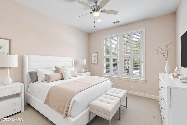 bedroom with baseboards, visible vents, a ceiling fan, and light colored carpet