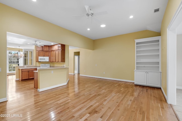 kitchen featuring a ceiling fan, light wood-style floors, range, white microwave, and visible vents