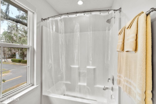 bathroom with shower / bath combination with curtain