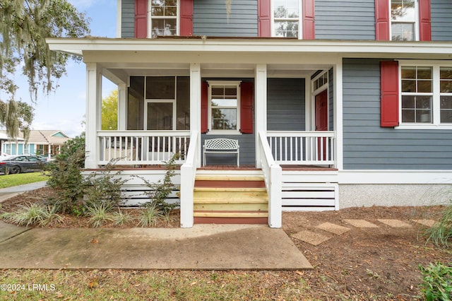 view of exterior entry with covered porch