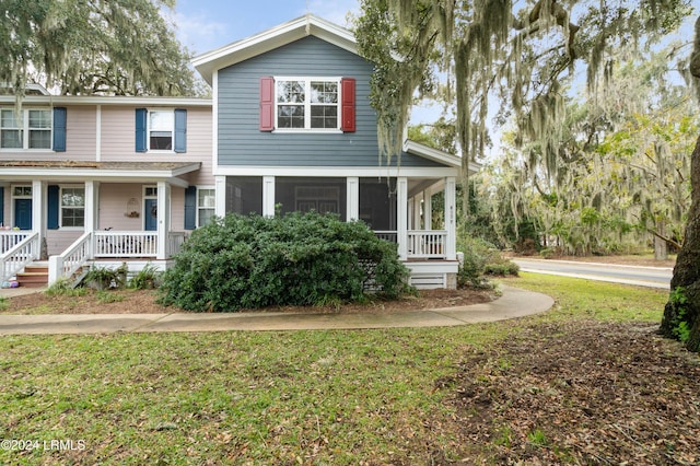 view of front of property with a front yard and covered porch