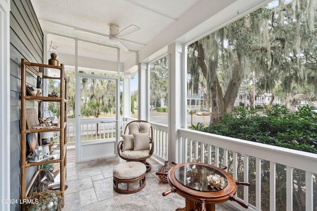 sunroom featuring ceiling fan