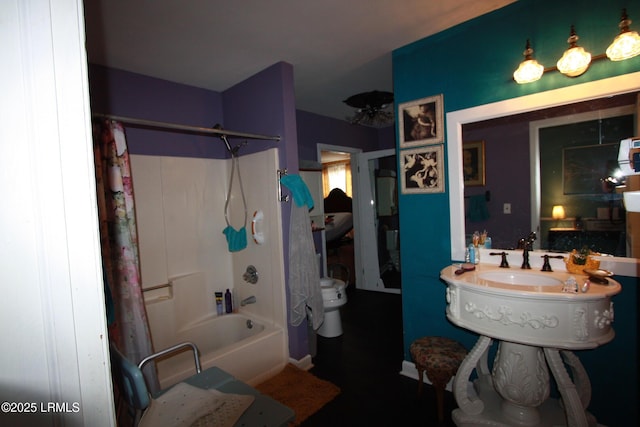 bathroom featuring shower / tub combo and toilet