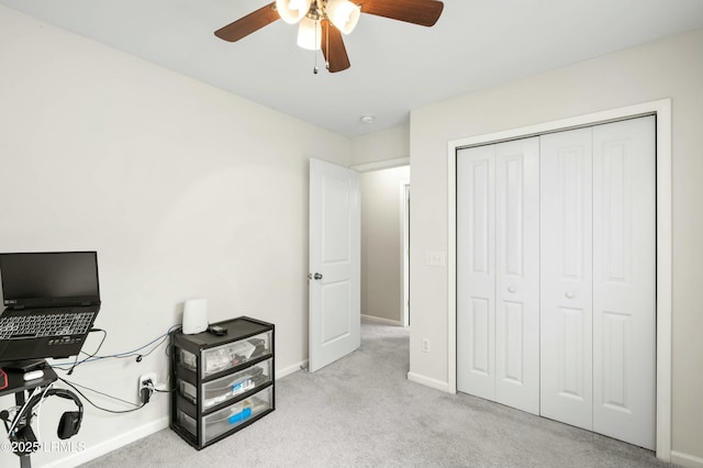 office space featuring light colored carpet and ceiling fan