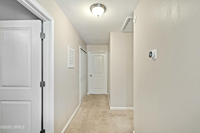 hallway featuring light colored carpet