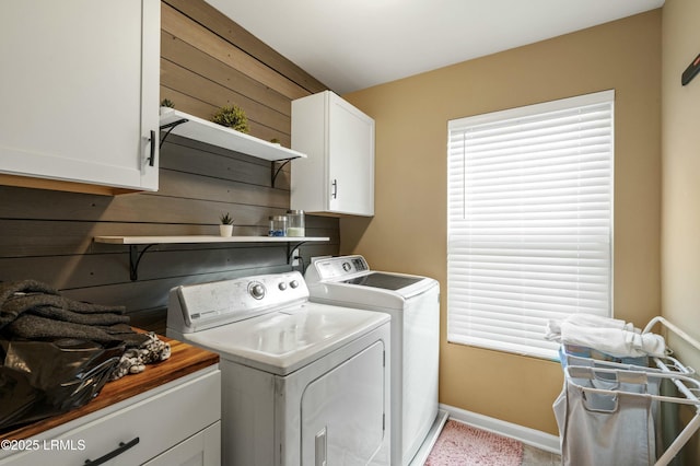 laundry area with cabinets, separate washer and dryer, and plenty of natural light